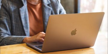 Woman using a MacBook on a desk