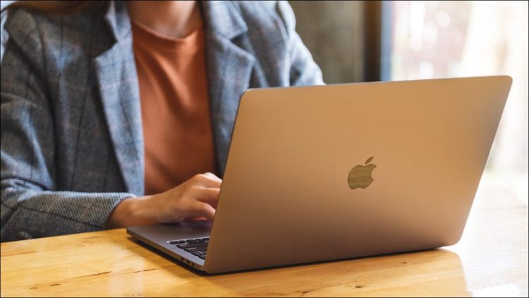 Woman using a MacBook on a desk