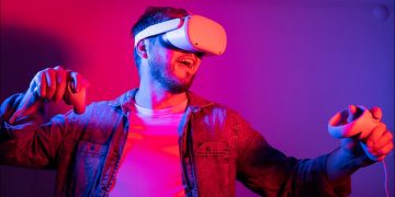 Man wearing a VR headset and holding his arms up in an action-ready pose.