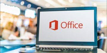 A laptop with the Microsoft Office logo on screen.