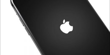 An iPhone turning on with the Apple logo visible.