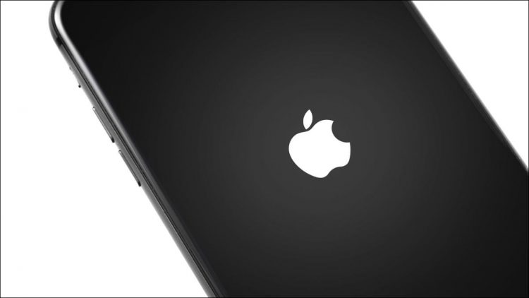 An iPhone turning on with the Apple logo visible.