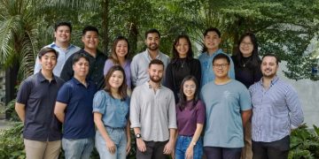 klikit's team posing outside in front of trees