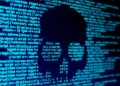 Computer code in the shape of a skull on a screen