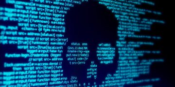 Computer code in the shape of a skull on a screen