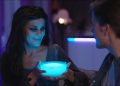 A woman dressed up as a vampire, holding a Govee portable smart light.