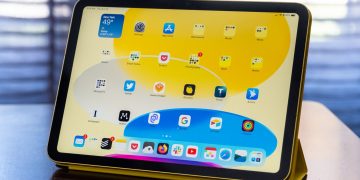 A 10th-gen iPad in an Apple Smart Folio on a wood table.