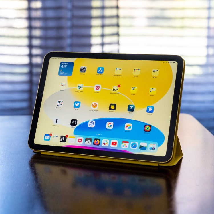 A 10th-gen iPad in an Apple Smart Folio on a wood table.