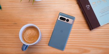 Pixel 7 Pro hazel on a table next to coffee