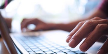 Hands typing on a keyboard