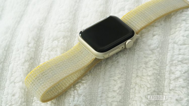 An Apple Watch SE 2 dries on a white towel.
