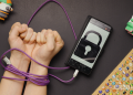 USB A to USB C cable wrapped around wrists connected to phone with lock icon