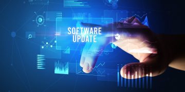 A hand activates the software update button in a virtual interface. [ update / patch / fix ]