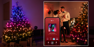A couple dances near a Christmas tree while their Philips Hue Festavia lights sync with jazz music.