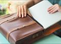 Person packing laptop into laptop bag