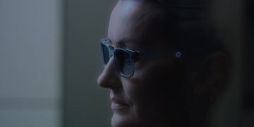 A person using a pair of AR glasses that look just like a regular pair of prescription glasses.